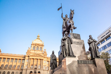 The bronze equestrian statue of St Wenceslas at the Wenceslas Square with historical Neorenaissance...