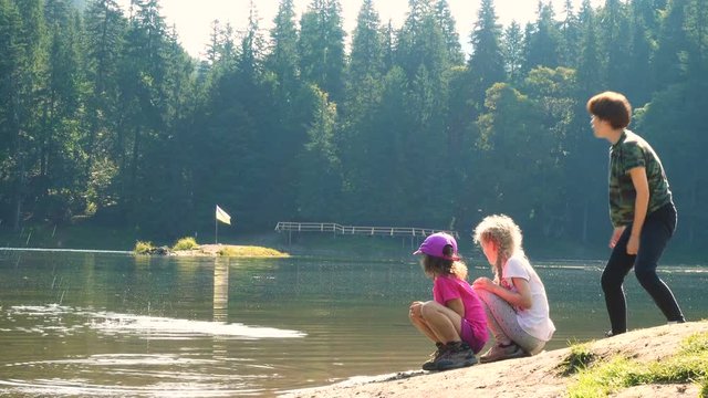 children playing near the lake