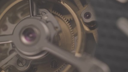 Mechanism of a watch with jewels. Open clockwork and fragments of shiny gears. Close up 4k macro shot. Time and work concept. - Powered by Adobe