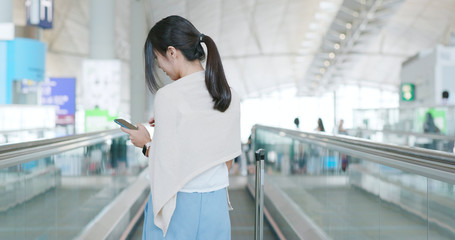 Woman use of mobile phone in the airport