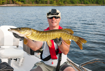 Happy angler with sea pike