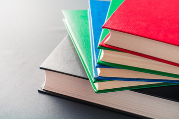 Beautiful colorful books lie on a gray background