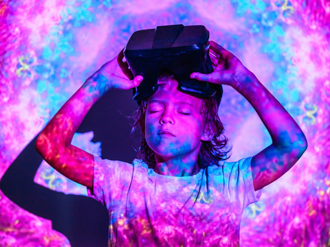 Focused boy with VR glasses under projection