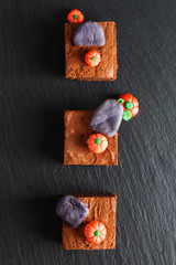 Halloween food idea Homemade organic fudge and crispy brownies with fondants pumpkins on top