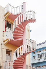 Residential buildings (block of flats) with interesting architectural detail - colorful spiral outdoor stairs. Singapore.
