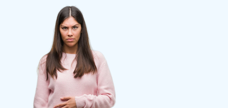 Young beautiful hispanic woman wearing a sweater skeptic and nervous, frowning upset because of problem. Negative person.