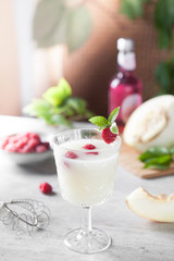 Cocktail of melon with raspberries. Pieces of melon.