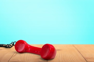 Red telephone receiver  on  background