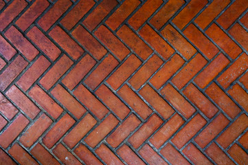 The path paved with red brick in zigzag pattern, Red stone walkway herringbone style pattern close-up
