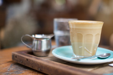 Hot latte on wooden table