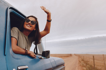 Happy woman enjoying road trip