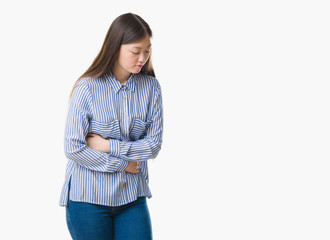 Young Chinese woman over isolated background with hand on stomach because nausea, painful disease feeling unwell. Ache concept.