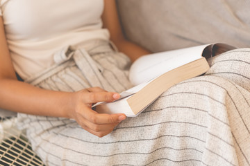 Close up unidentified woman reading book on her lap