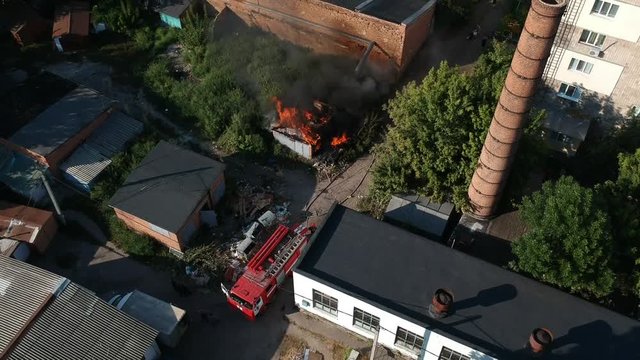 Garage in fire in middle of the city in east Europe sunny weather