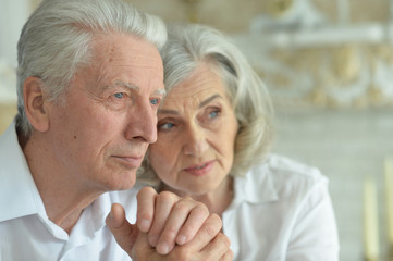 Portrait of a sad senior couple at home