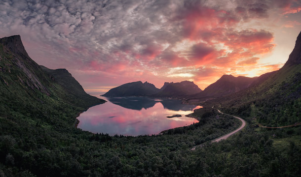 Beautiful landscape view of a fjord and mountains during epic sunset