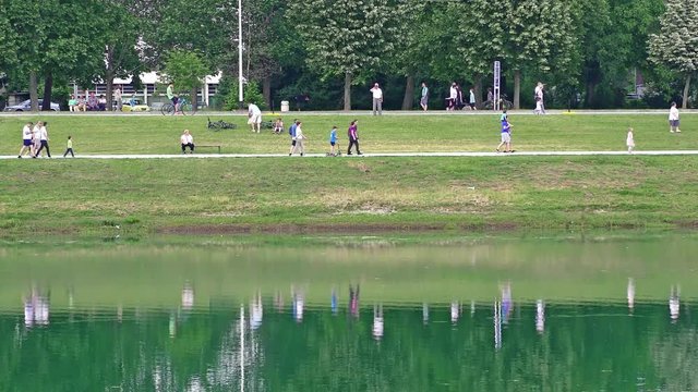 People walking along the shore of Lake Jarun in Zagreb, 4K video