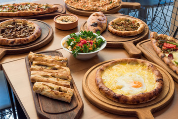 Variety of Turkish Pide Traditional food with beef, Cheese, Fried Egg and Salad.