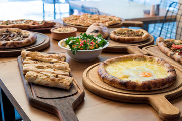 Variety of Turkish Pide Traditional food with beef, Cheese, Fried Egg and Salad.