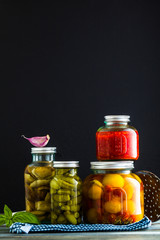 Preserved vegetables on wooden background. Autumn cans for the winter