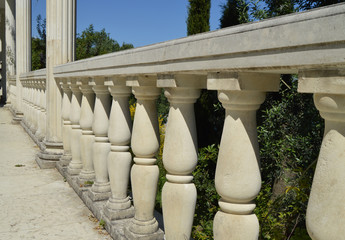 Close-up details of the balustrade, white marble columns, illuminated by the sun