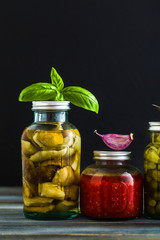 Preserved vegetables on wooden background. Autumn cans for the winter