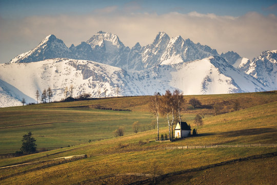 Landscape with a chapel and snow-covered Tatra Mountains in Kacwin, Malopolskie, Poland