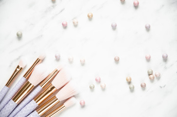 Make-up brushes on marble background. Top view, flat lay