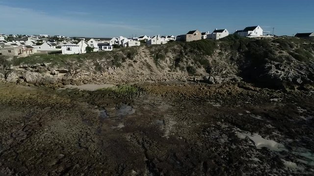 Aerial footage over the small holiday and fishing village of Arniston along the overberg coastline in South Africa