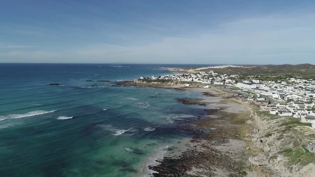 Aerial footage over the small holiday and fishing village of Arniston along the overberg coastline in South Africa