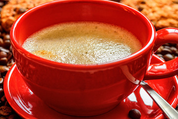 a cup of coffee on a background of coffee beans