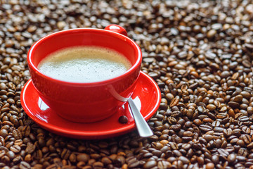 a cup of coffee on a background of coffee beans