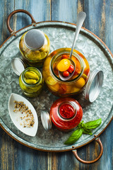 Preserved vegetables on wooden background. Autumn cans for the winter