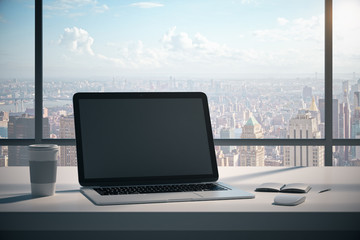 Modern desktop with blank laptop