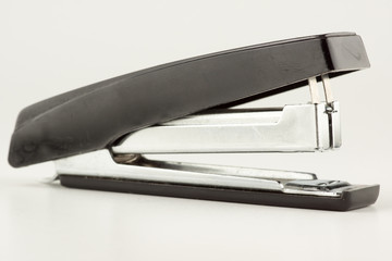 stapler for stapling papers on a table