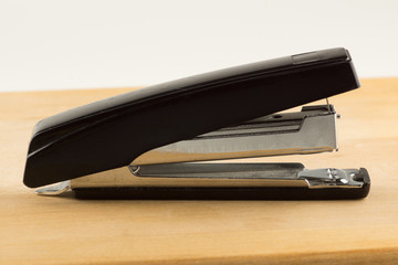 stapler for stapling papers on a table