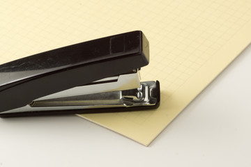 stapler for stapling papers on a table