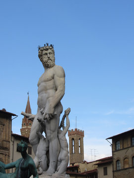 The Neptune fountain and Palazzo Vecchio in Florence, Italy . Detail of the Neptune statue