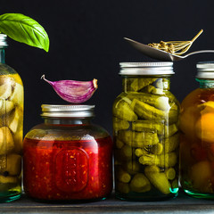 Preserved vegetables on wooden background. Autumn cans for the winter