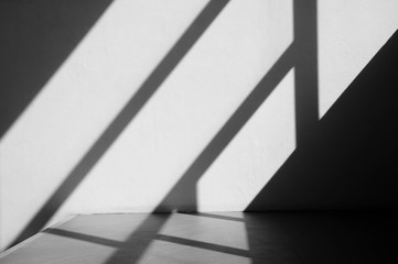 Abstract background of a white wall with shadows from the window. - monochrome