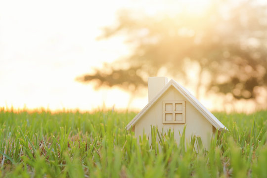 Image of vintage house in the grass, garden or park at sunset light.