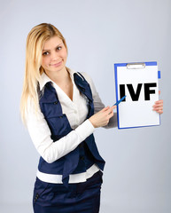 IVF. A woman shows on her tablet the abbreviation in vitro fertilization