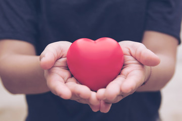 Red heart ball : Stress reliever foam ball the red heart shape on woman hand. Gift valentine's Day