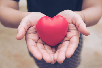 Red heart ball : Stress reliever foam ball the red heart shape on woman hand. Gift valentine's Day