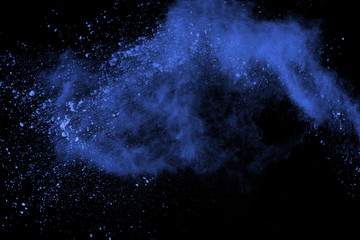 Fototapeta na wymiar Blue powder explosion on black background. Colored cloud. Color dust explode. Paint Holi.