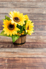 Fototapeta premium Wooden Flowerpot filled with Sunflowers