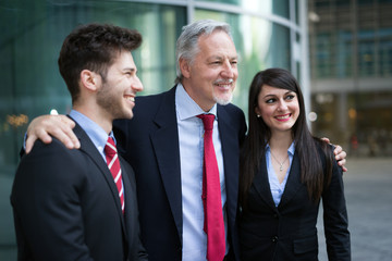 Smiling businessman and young colleagues