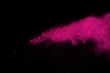 Abstract pink powder explosion on black background. abstract colored powder splatted, Freeze motion...