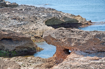 Natural coastal summer landscape rock bridge and crystal blue ocean.