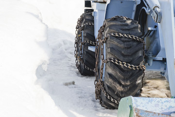 Tractor rides and cleans the road from the snow to the blizzard